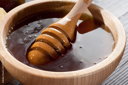 wood bowl with honey and spoon