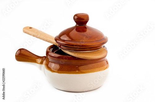 Fotografie Brown soup crock with wooden spoon