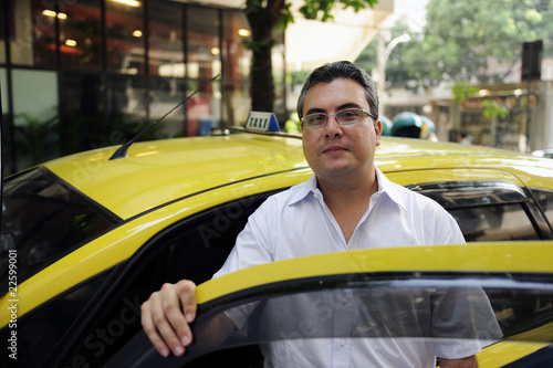 portrait of a taxi driver with cab