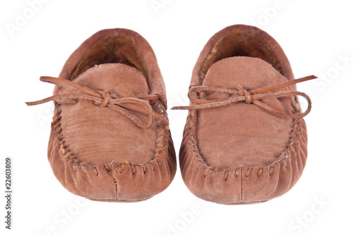 Pair of moccasin slippers isolated on white photo