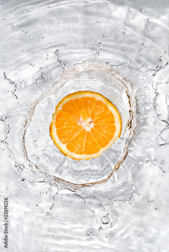 Fototapeta Naklejka Na Ścianę i Meble -  Fresh orange dropped into water with bubbles isolated on white