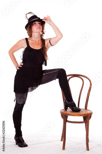 Cabaret dancer posing with leg on chair