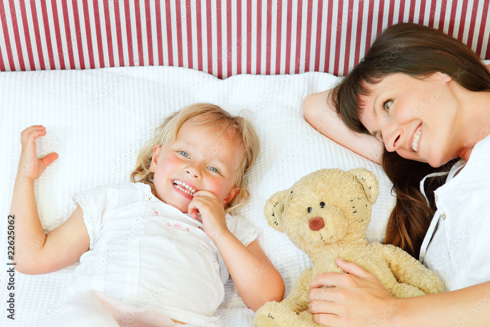 Bed time - happy mother and daughter in bed. Bed time - happy mother and daughter in bed.
