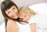 Mother and daughter in bed. Shallow DoF. Focus on daughter.