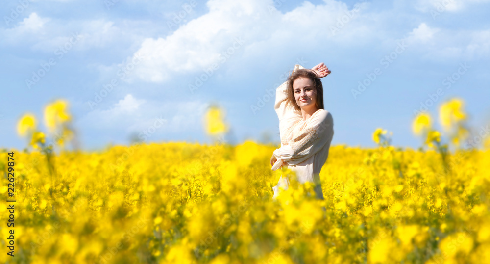 young happy girl in yellow flowers