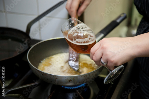 cooking beer risotto in restaurant kitchen