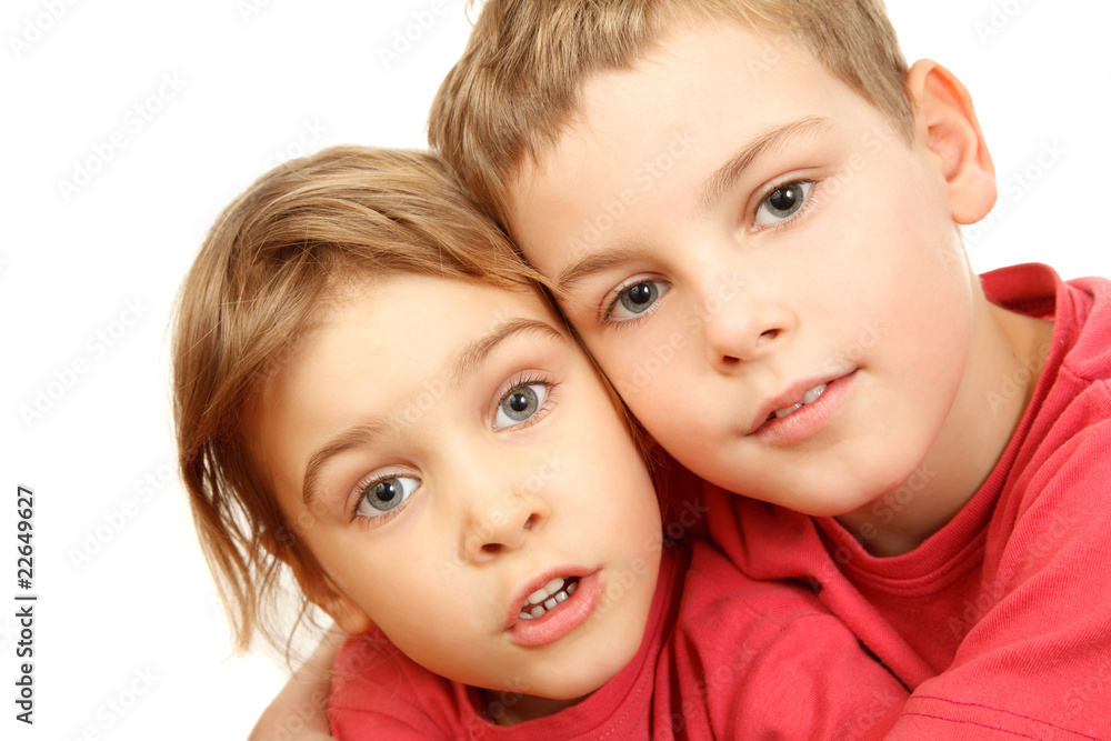 Brother and sister embracing look at camera. Isolated Brother and sister embracing look at camera. Isolated