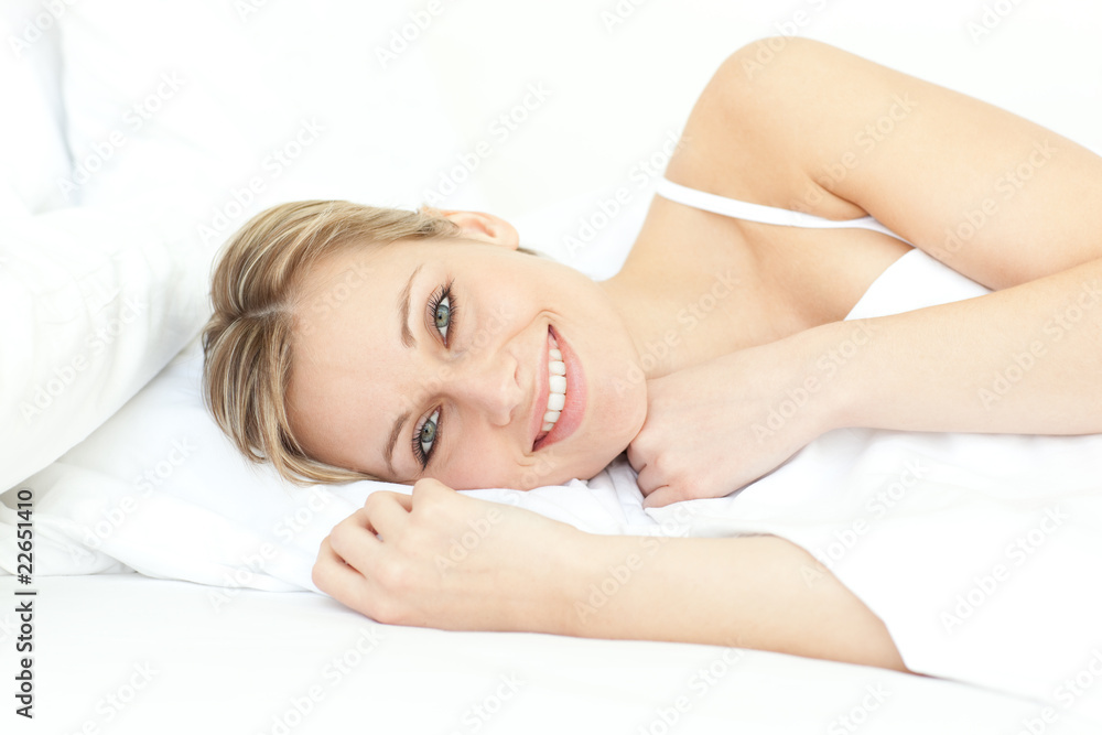 Jolly woman relaxing lying on a bed Jolly woman relaxing lying on a bed
