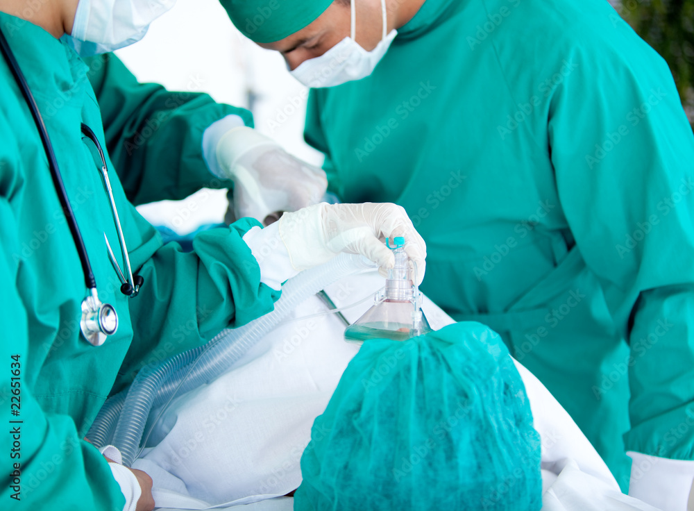 Medical team using equipment on the patient Medical team using equipment on the patient