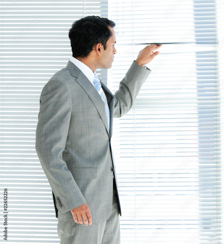 Fototapeta premium Confident businessman looking through a window
