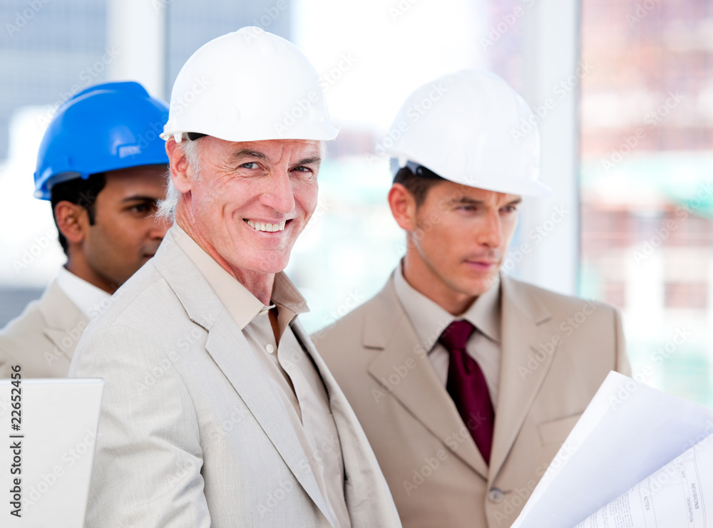 Smiling architect team working on a building project Smiling architect team working on a building project