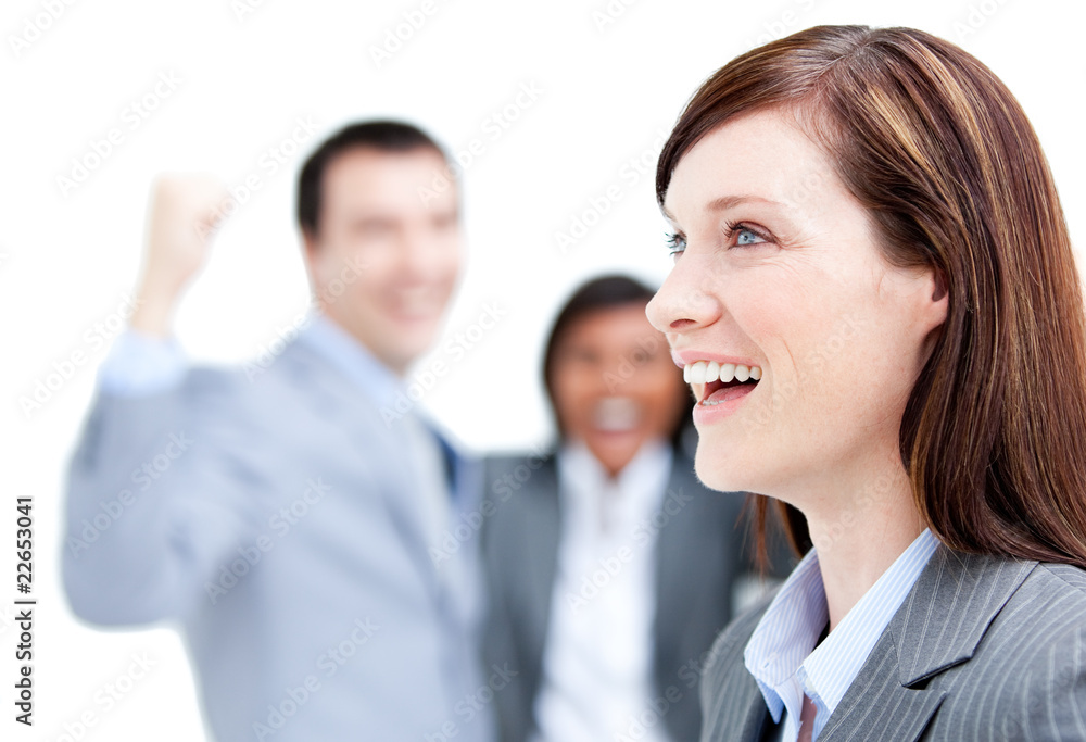 Laughing businesswoman standing with her team against a white ba Laughing businesswoman standing with her team against a white ba