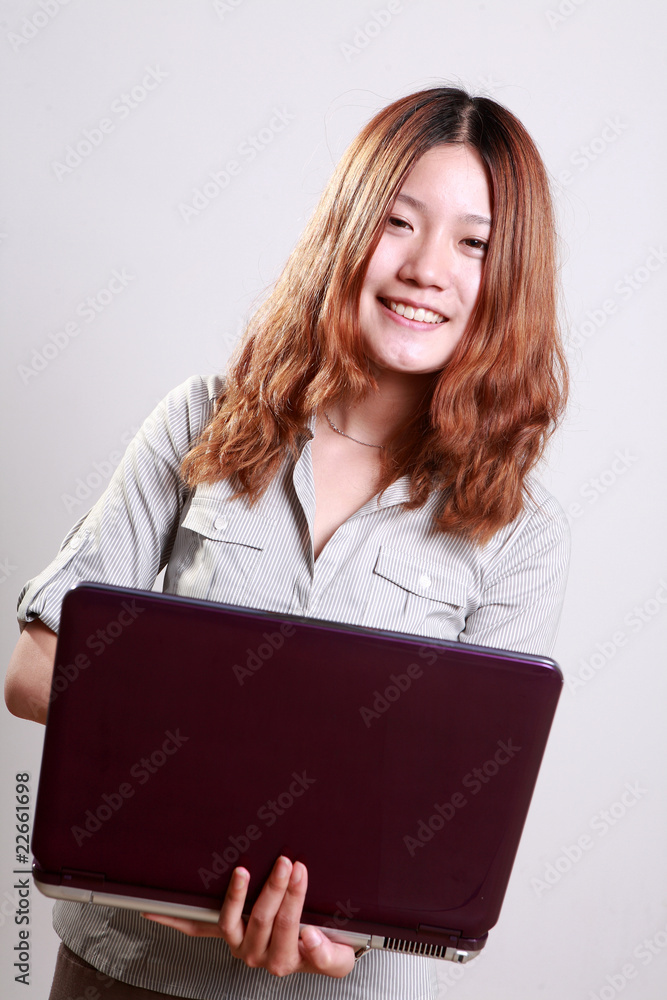 Laughing woman using a laptop against a white background . Laughing woman using a laptop against a white background .