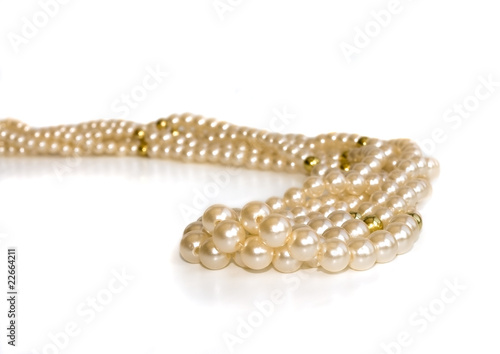 Triple strand simulated pearl necklace on a silver background
