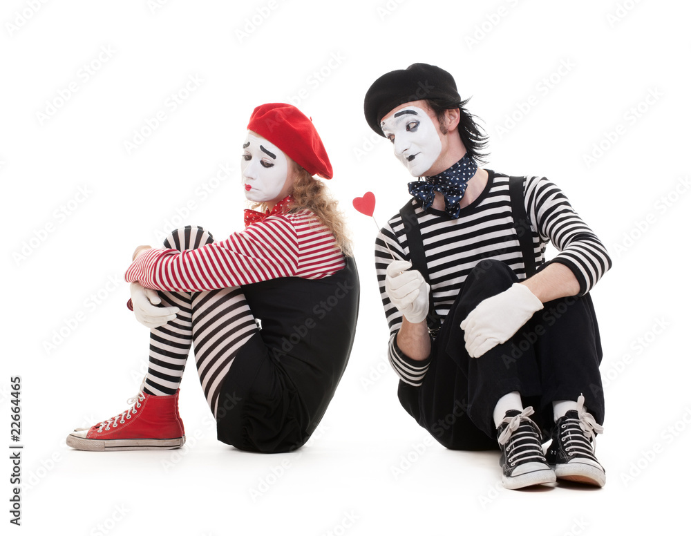 smiley man giving heart to sad woman smiley man giving heart to sad woman