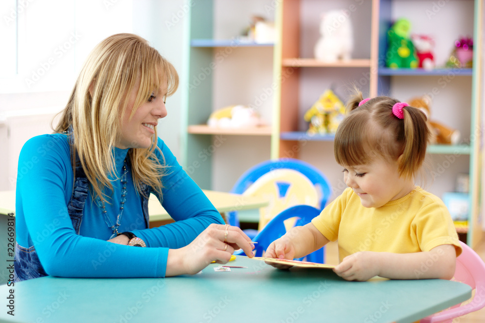 Teacher with child in preschool Teacher with child in preschool