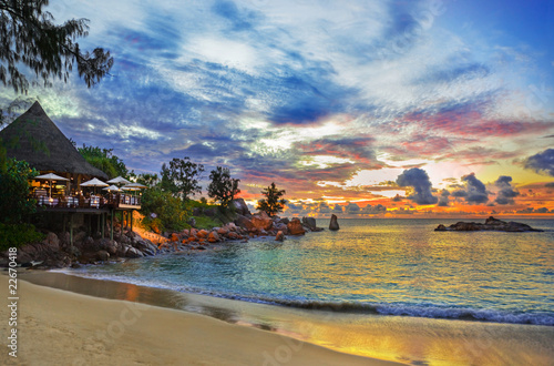 Cafe on tropical beach at sunset photo