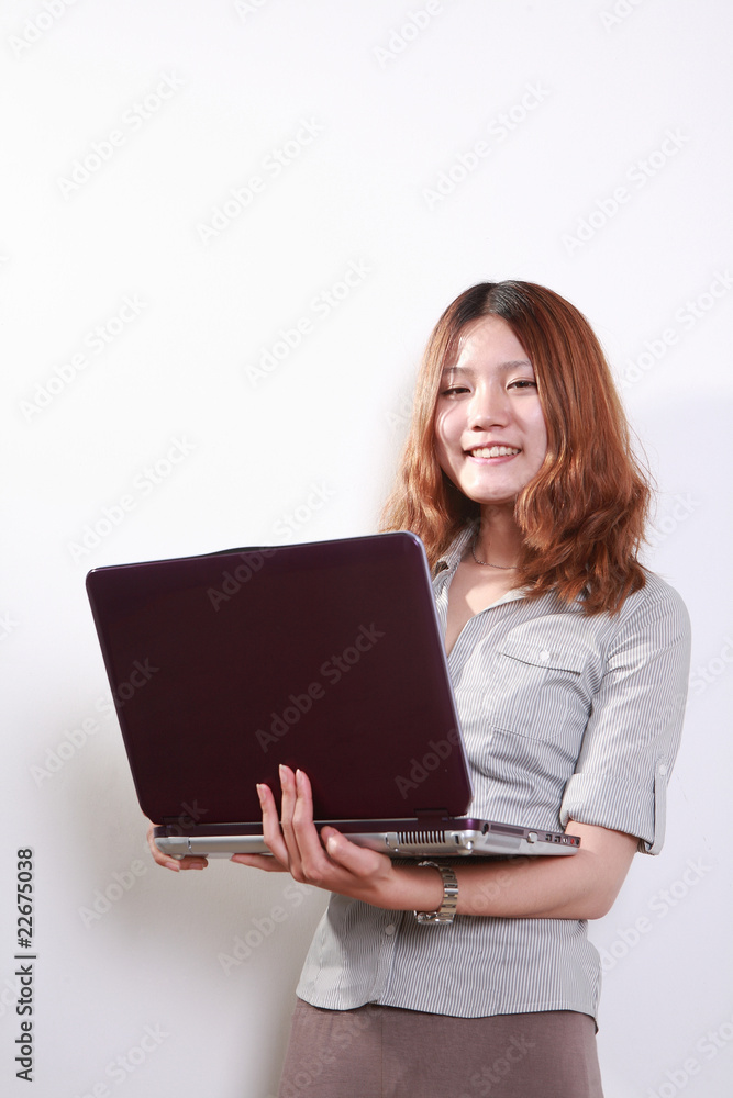 Laughing woman using a laptop against a white background . Laughing woman using a laptop against a white background .
