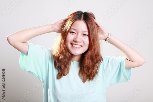 Asian female model posing in bright blue t-shirt