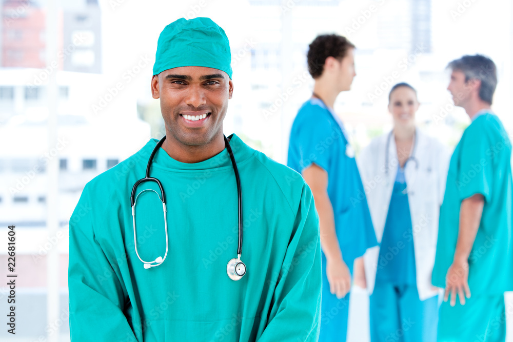 Afro male doctor looking at the camera while his medical partner Afro male doctor looking at the camera while his medical partner