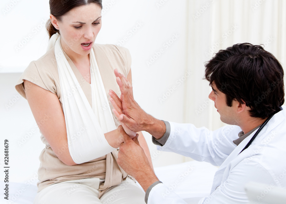 Professional male doctor examining the female patient by taking Professional male doctor examining the female patient by taking