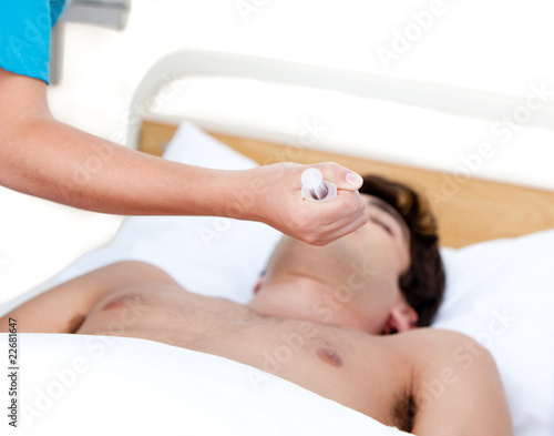 Doctor holding a syringe to reanimate an inconscious patient