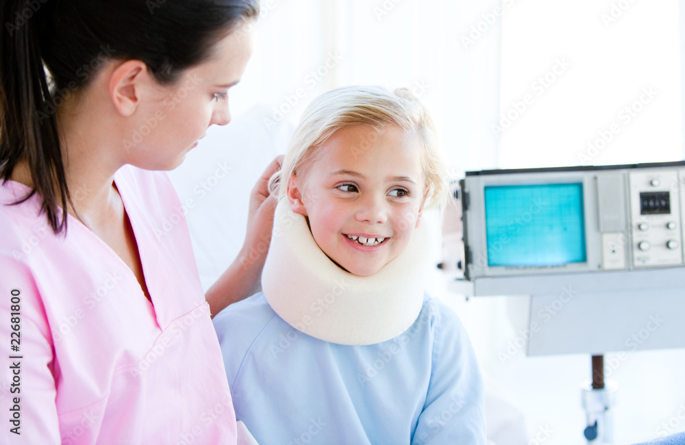 Adorable little girl with a neck brace sitting with her nurse