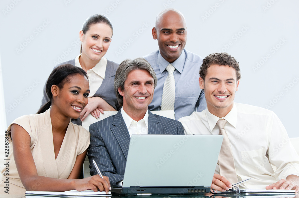Smiling internationnal businessteam working with at the laptop Smiling internationnal businessteam working with at the laptop