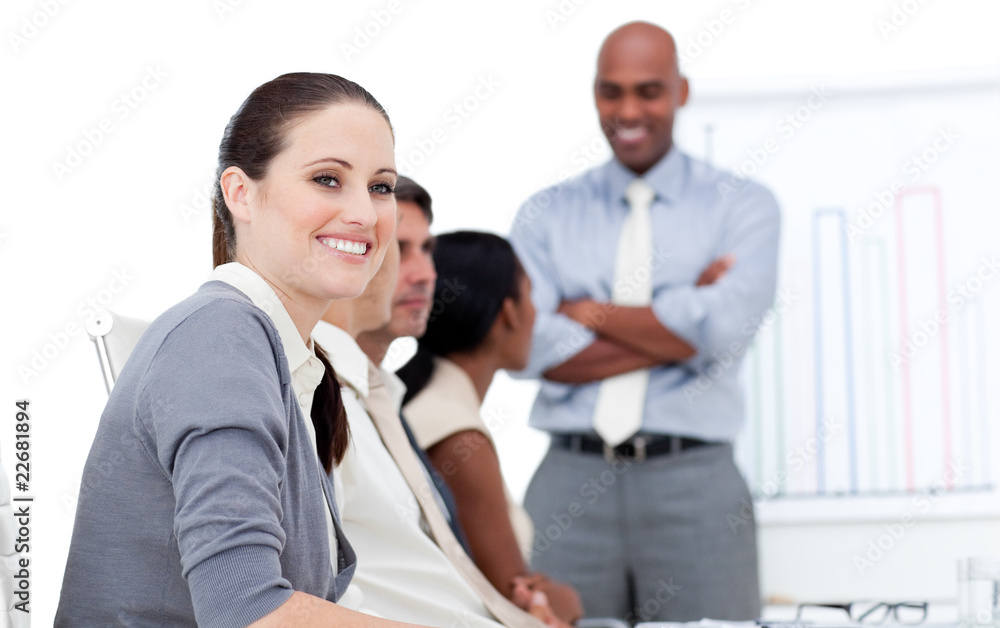 Smiling businesswoman looking at the camera during a meeting wit