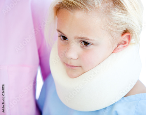 Close-up of a little girl with a neck brace photo