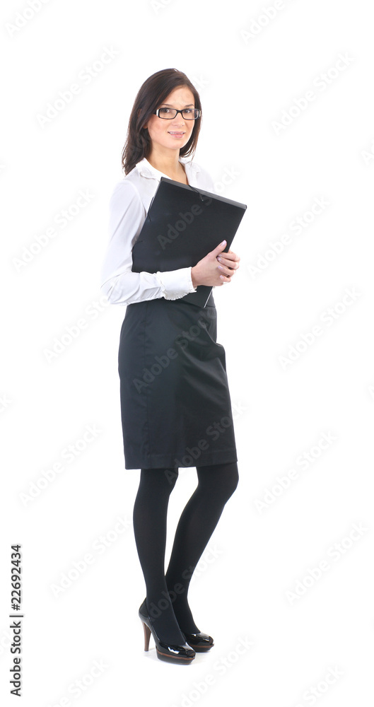 A young business woman is standing with a notebook A young business woman is standing with a notebook