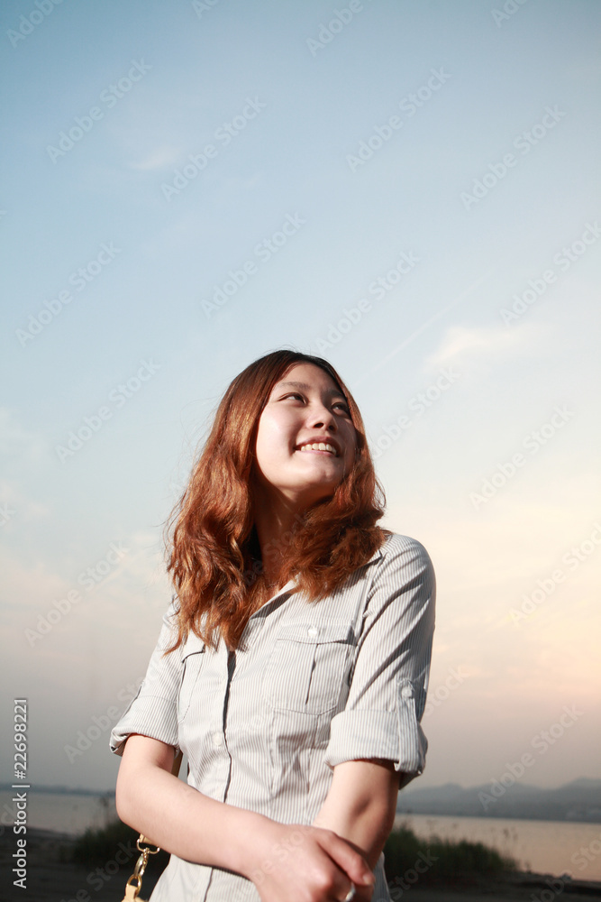 Beautiful young woman on the beach at sunset . Beautiful young woman on the beach at sunset .