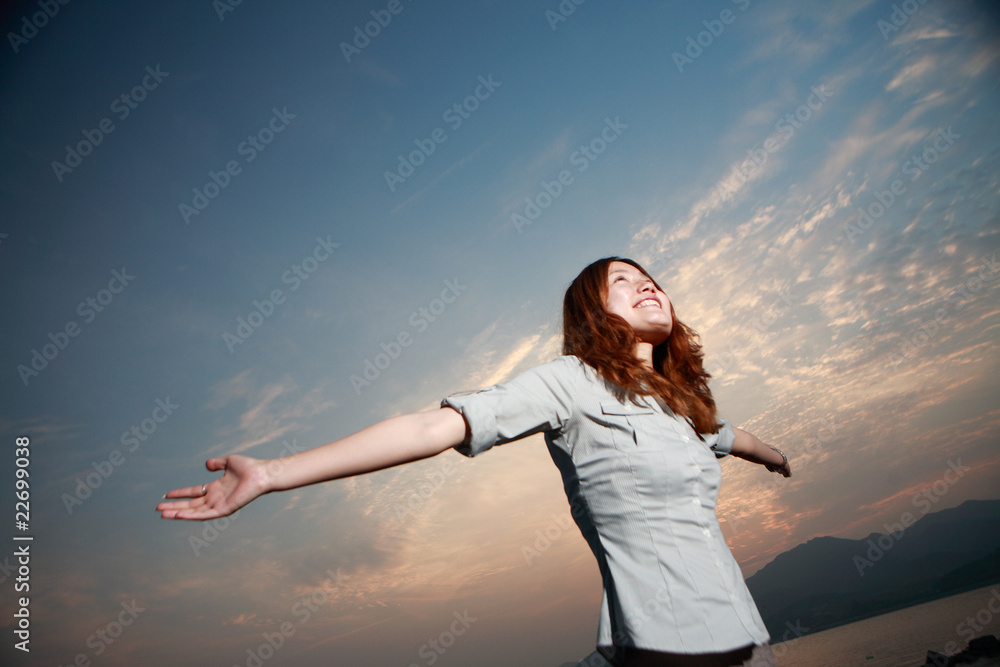 Beautiful young woman on the beach at sunset . Beautiful young woman on the beach at sunset .