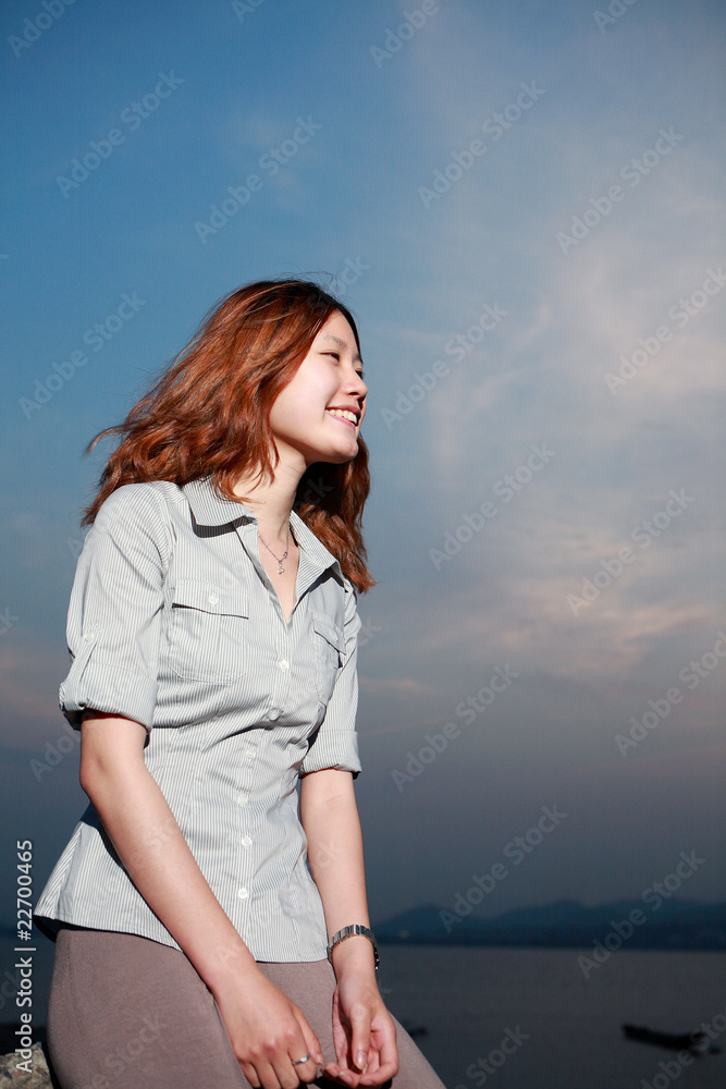 Beautiful young woman on the beach at sunset . Beautiful young woman on the beach at sunset .