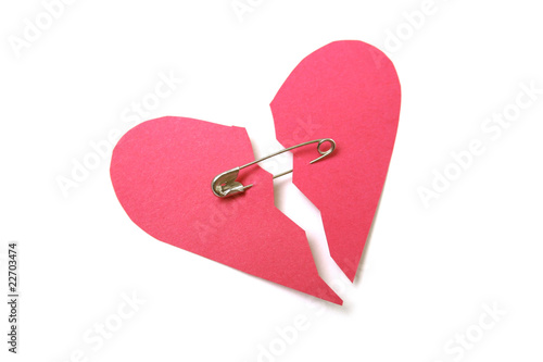 Red paper heart torn in half secured with safety pin photo