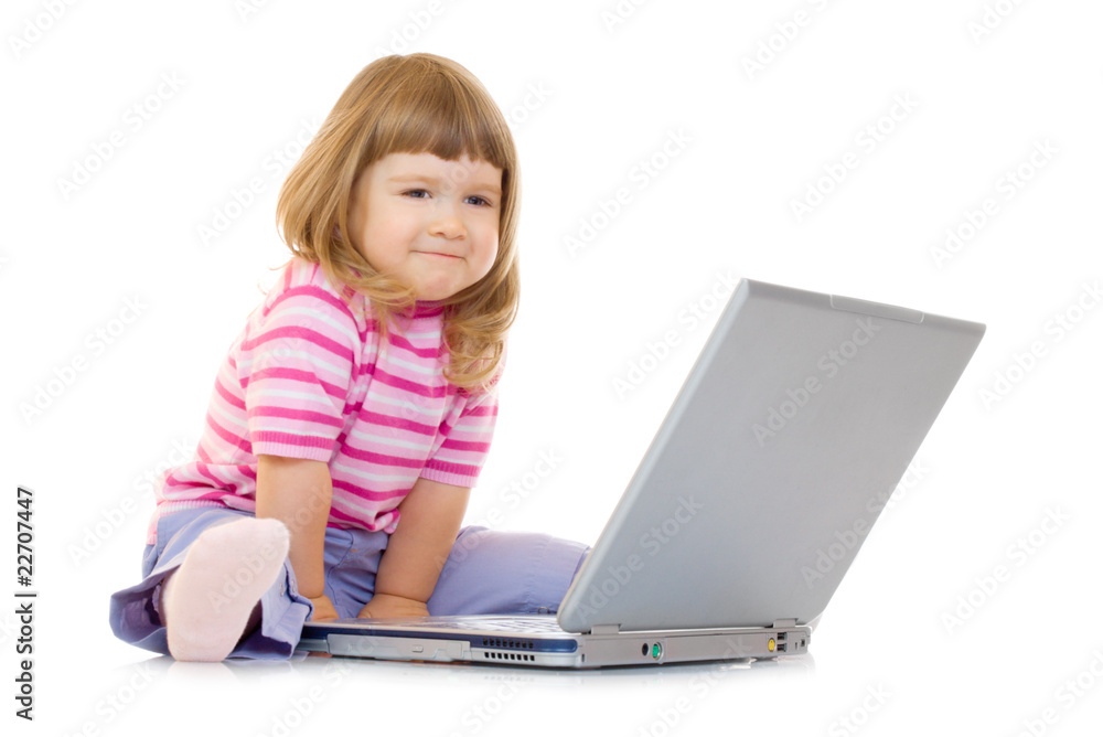 Little smiling girl with laptop