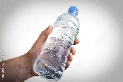 hand holding a bottle of water