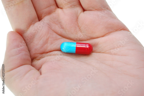 Hand holding a pill