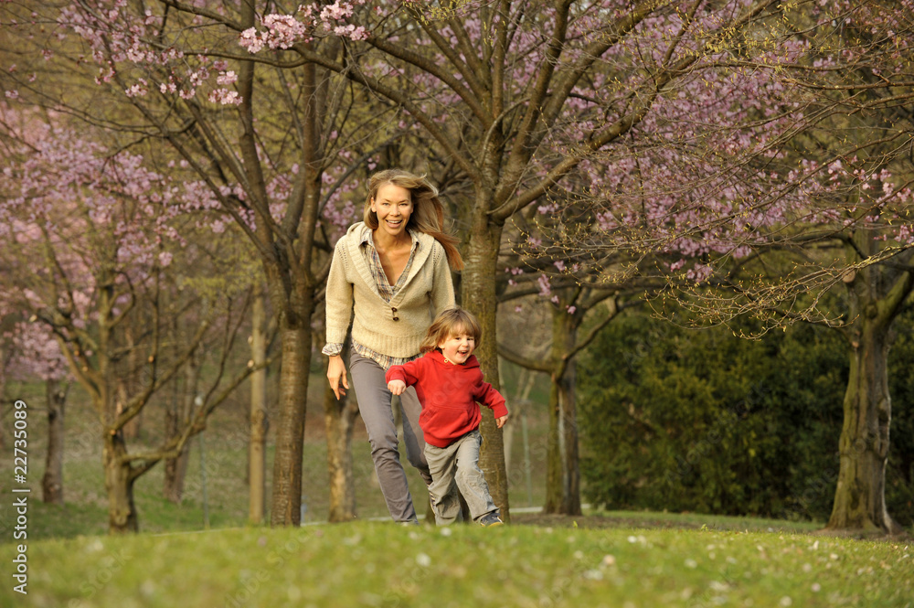 Blossom trees in the park with mother and child Blossom trees in the park with mother and child