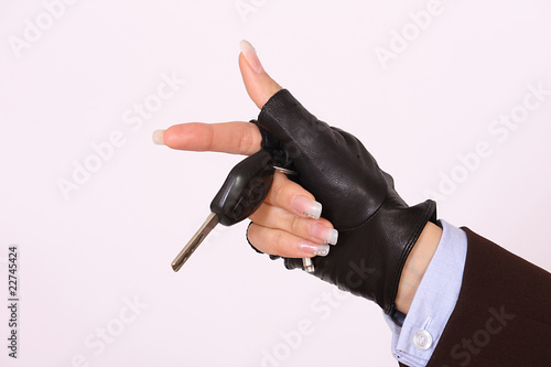 Female gloved hand holding a car keys