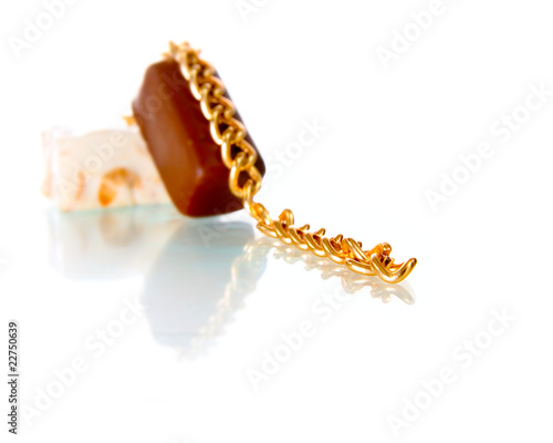 Gold chain and chocolate candy photo