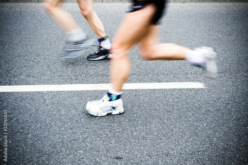 People running in marathon race on city streets