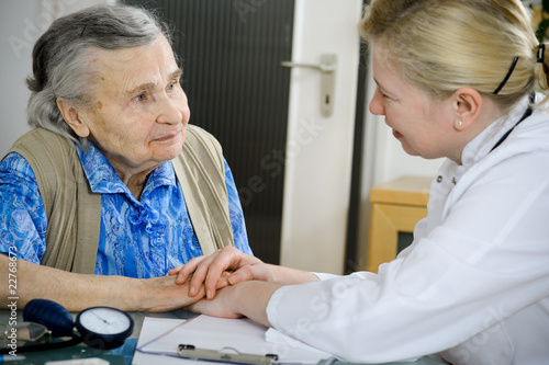 An elderly women being examined by a doctor