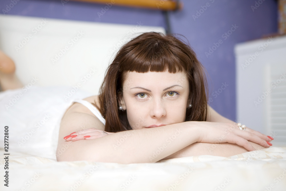 Fototapeta premium serious woman lying on bed