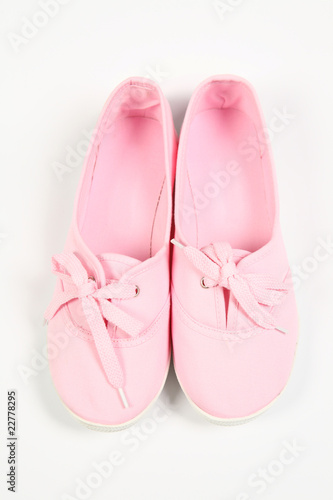 a pair of pink women shoes and white background