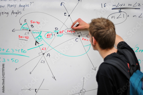 Fototapeta Student writing math on whiteboard