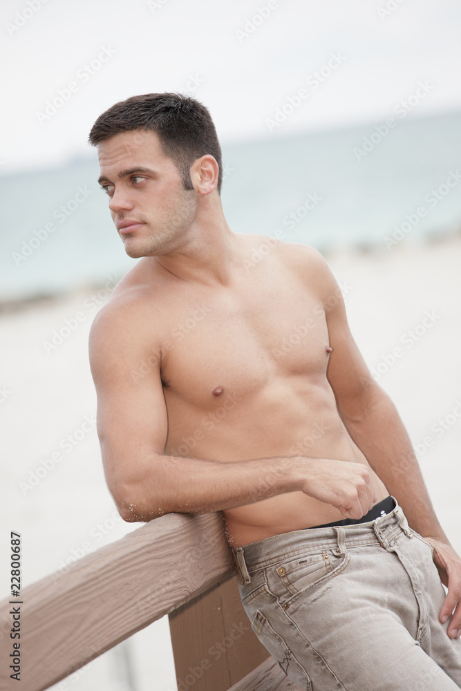 Handsome man on the beach without his shirt