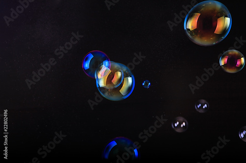 Soap bubbles on black background .