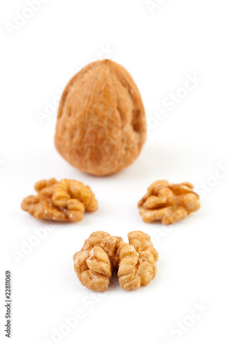 pieces and whole walnut over white background