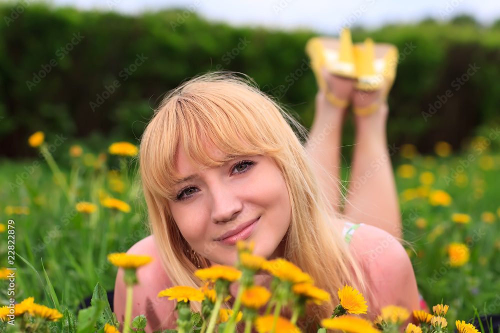 young woman laying down in meadow young woman laying down in meadow